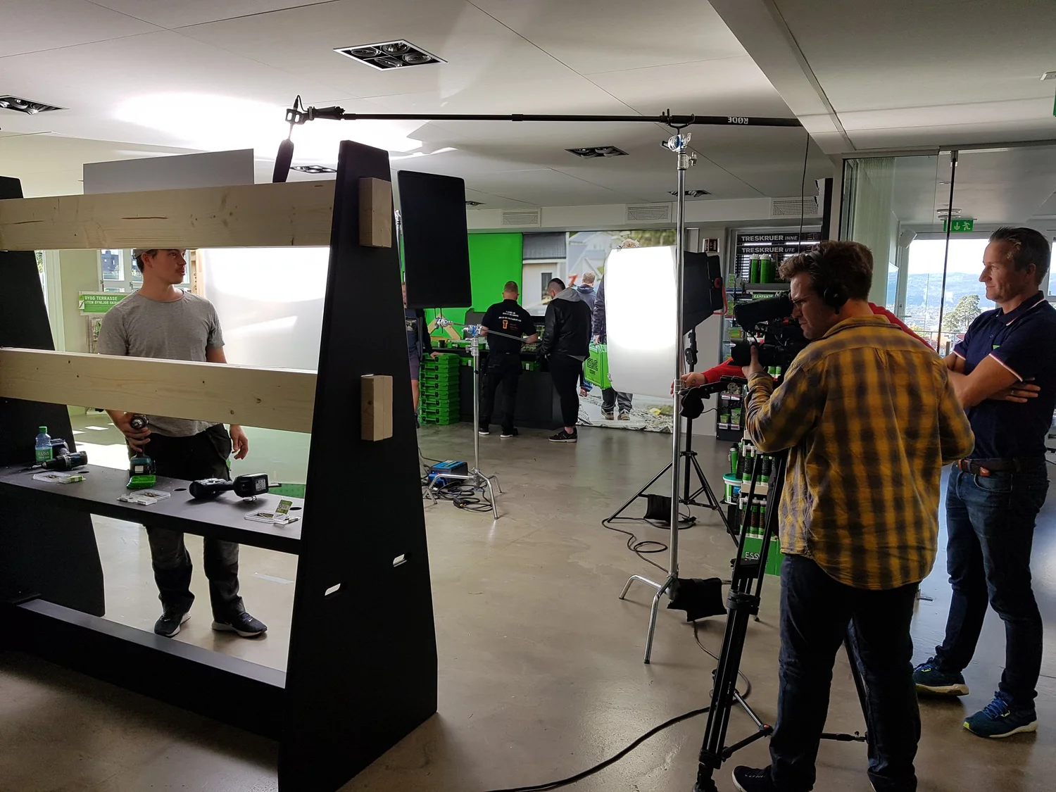Noblewolf crew on a commercial set: camera operator, boom microphone and softbox lighting around a product display